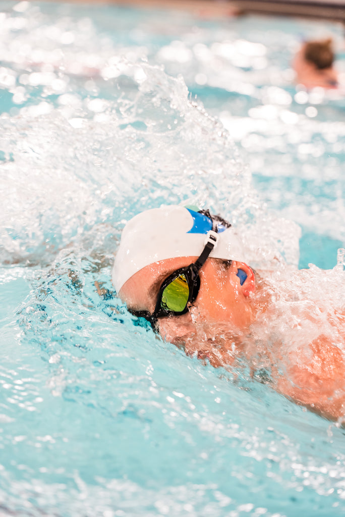 Female swimmer wearing TRI-FIT RAPID-X swim goggles in black