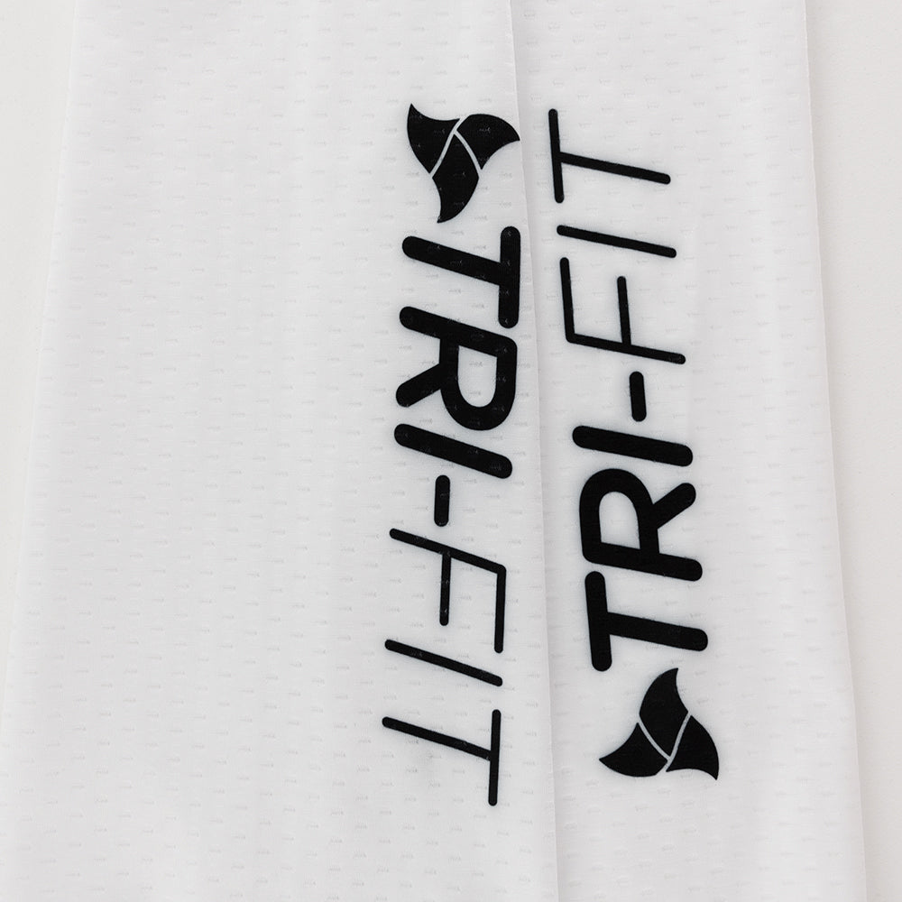 Close-up of the black TRI-FIT logo printed on white CORE Calf Sleeves with a dimpled texture.