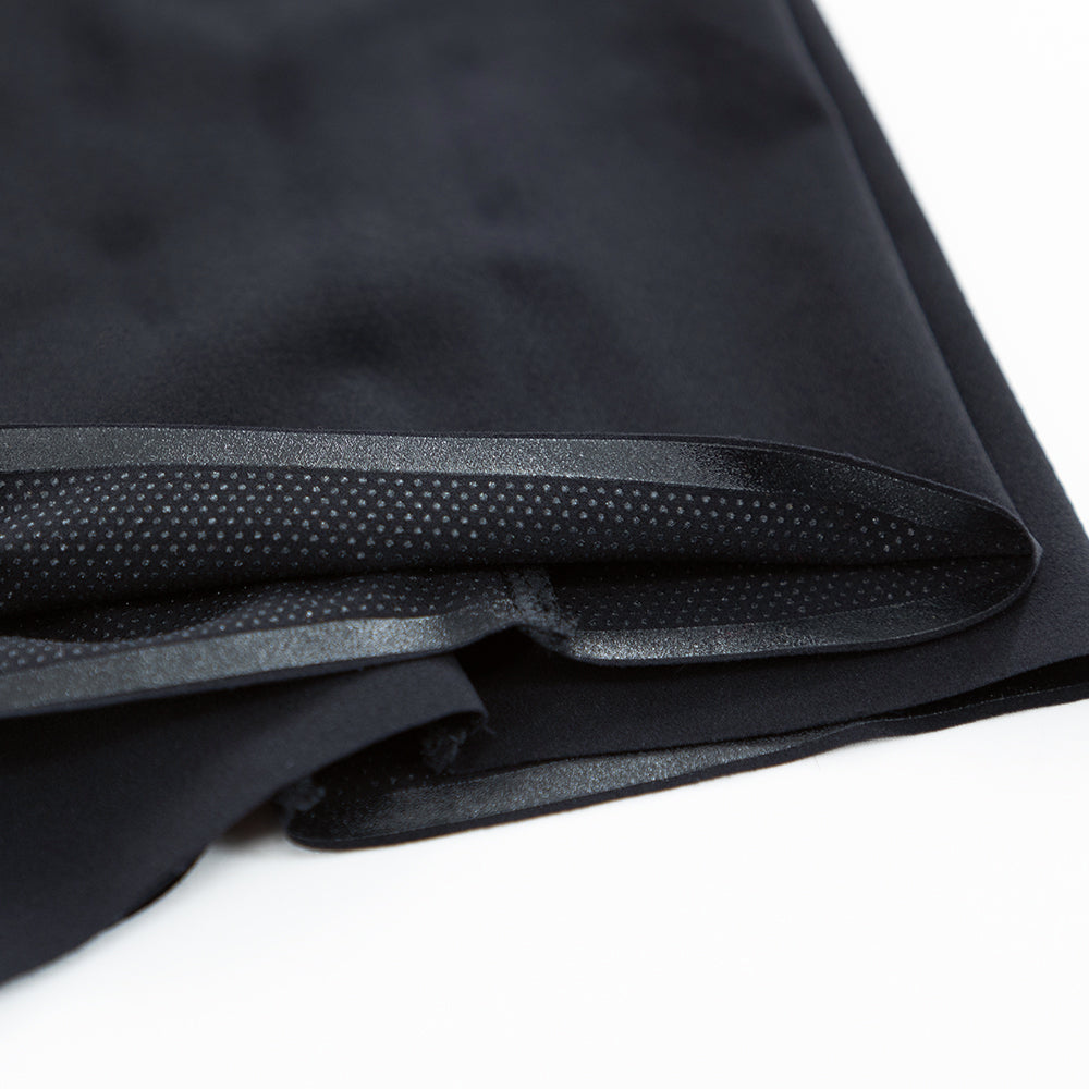 Detail of the laser-cut leg hem and integrated gripper on the white/black VORTEX triathlon suit