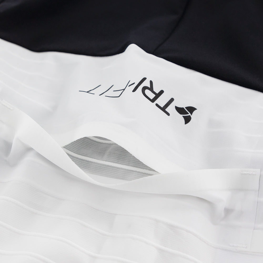 Open rear pocket of the white/black VORTEX triathlon suit showing integrated storage system