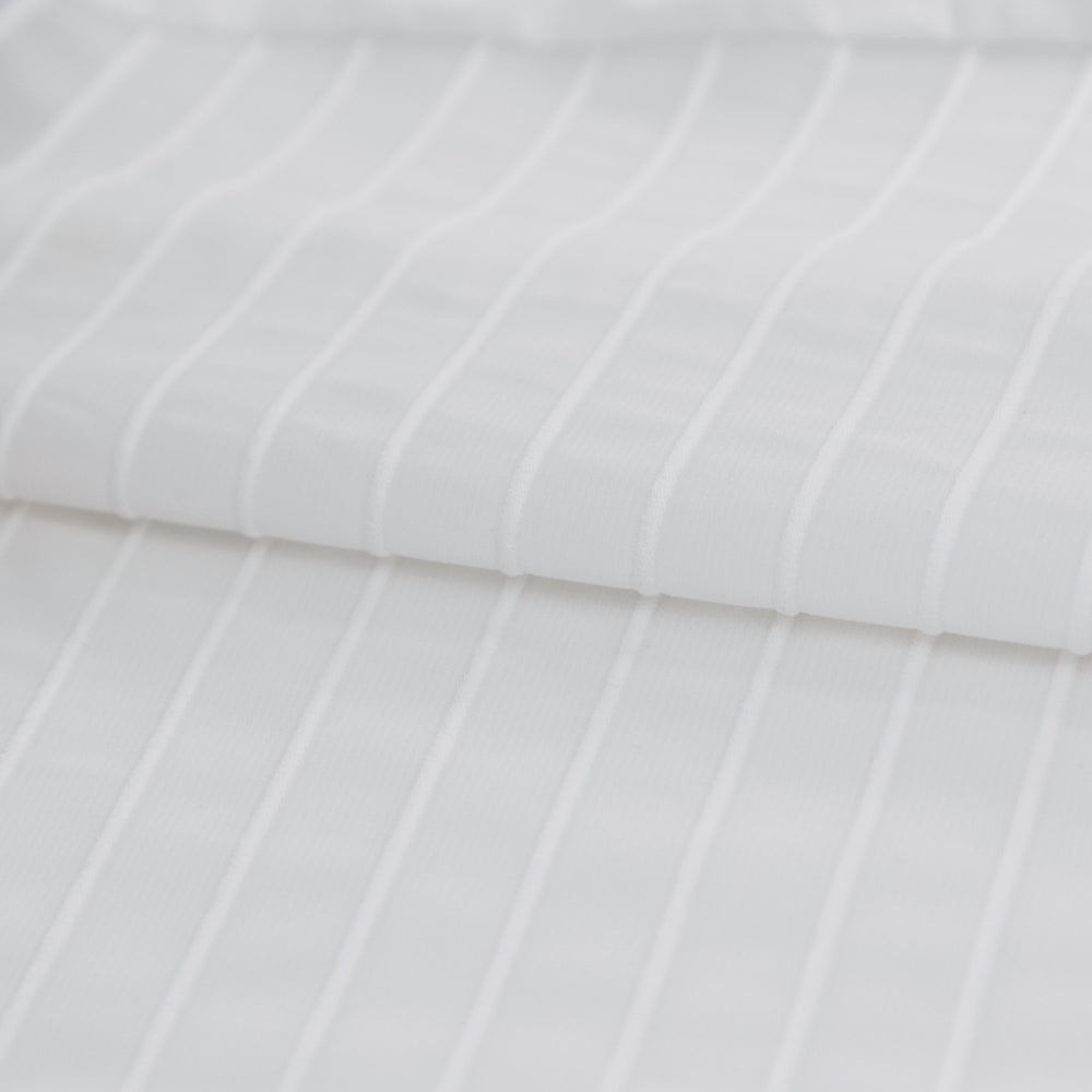 Close-up of the ribbed aero fabric used in the upper section of the white/black VORTEX triathlon suit
